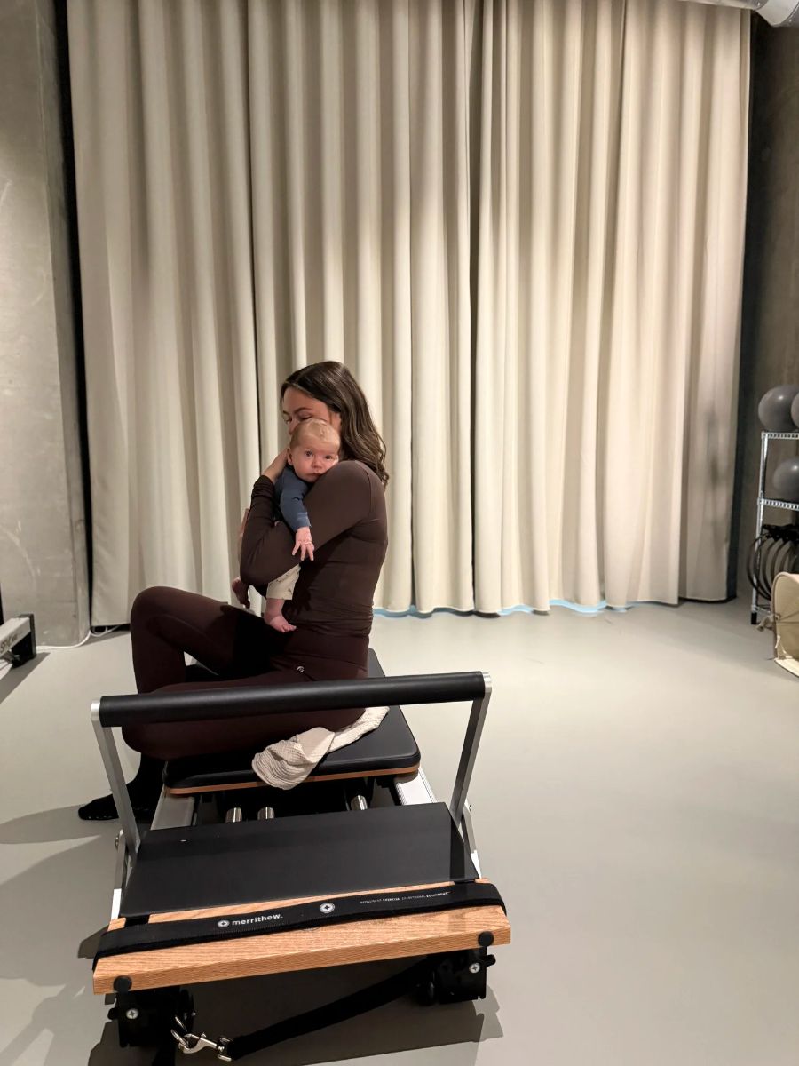 Mother holding her baby while sitting on a reformer at Sink Mama, Sink Reformer, Aarhus