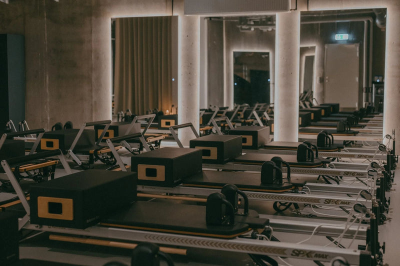 Rows of reformer machines in the Sink Reformer studio in Aarhus Ø